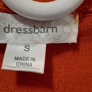 Rust color sweater, low v-neck. 52% cotton, 27%acrylic, 19% Nylon, 2% spandex